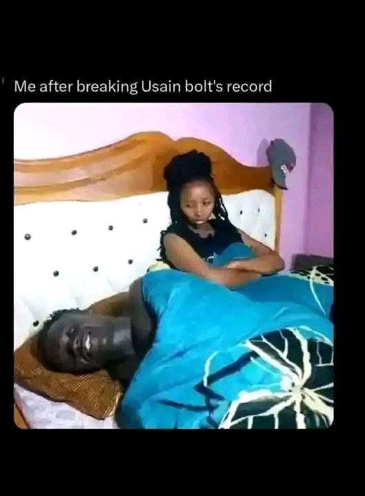 a woman laying on a bed with a man